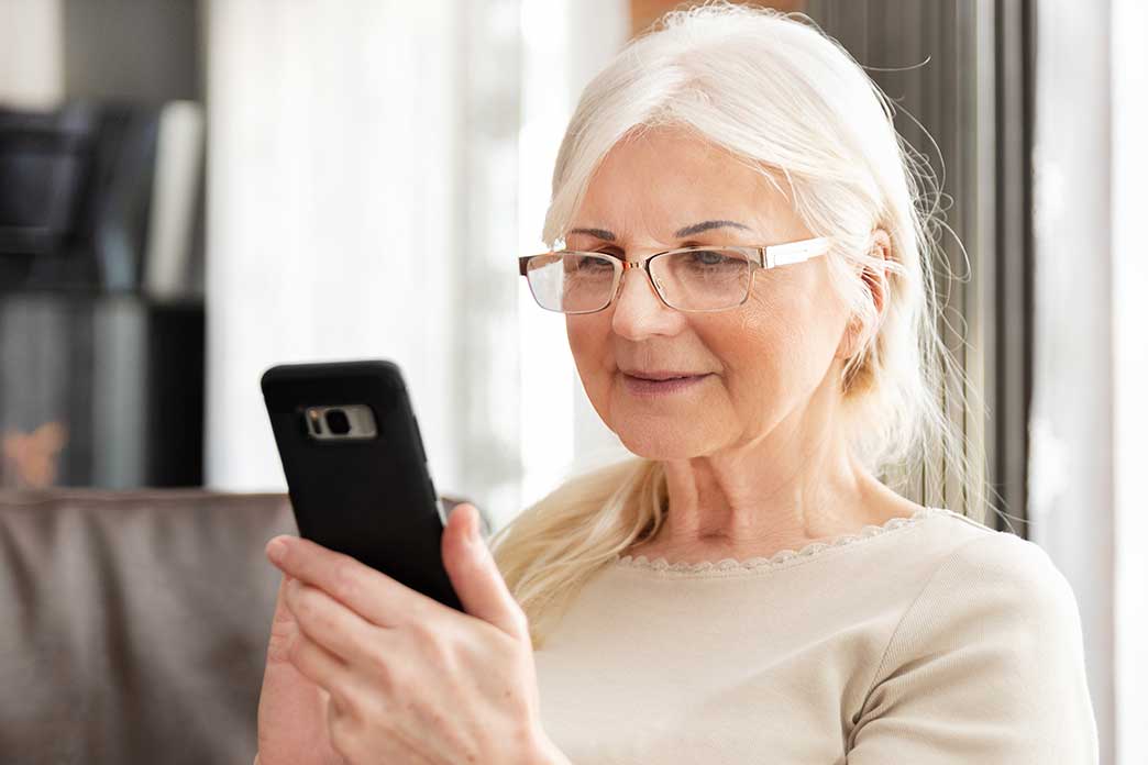 Elderly woman using her phone